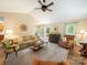 Spacious living room with vaulted ceilings, ceiling fan, neutral carpet and a view of the deck through French doors at 1505 Moss Springs Rd, Albemarle, NC 28001
