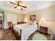Main bedroom boasts a ceiling fan, rocking chair, wood-look floors, and neutral paint at 1505 Moss Springs Rd, Albemarle, NC 28001