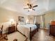 Bright main bedroom featuring a tray ceiling, ceiling fan, and hardwood floors at 1505 Moss Springs Rd, Albemarle, NC 28001