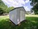 Durable metal shed providing extra storage space and convenience in the backyard at 1505 Moss Springs Rd, Albemarle, NC 28001