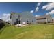 Spacious backyard featuring a patio with outdoor furniture and a well-maintained lawn at 177 Willow Valley Dr, Mooresville, NC 28115