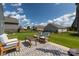 Inviting backyard patio with stylish outdoor furniture and a green lawn at 177 Willow Valley Dr, Mooresville, NC 28115