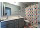 Bright bathroom with double sinks, large mirror, and colorful shower curtain at 177 Willow Valley Dr, Mooresville, NC 28115