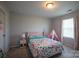 Bright bedroom featuring a pink tent, decorative pillows, and a patterned bedspread at 177 Willow Valley Dr, Mooresville, NC 28115