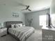 Comfortable bedroom features a tufted headboard, ceiling fan, and neutral decor at 177 Willow Valley Dr, Mooresville, NC 28115