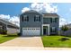 Charming two-story home with a well-maintained lawn, a two-car garage, and a welcoming front entrance at 177 Willow Valley Dr, Mooresville, NC 28115