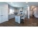 Modern kitchen with an island, granite countertops, stainless steel appliances, and sleek gray cabinetry at 177 Willow Valley Dr, Mooresville, NC 28115