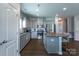 Modern kitchen with an island, granite countertops, stainless steel appliances, and sleek gray cabinetry at 177 Willow Valley Dr, Mooresville, NC 28115