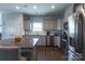 Bright and modern kitchen with stainless steel appliances, granite countertops, and a functional center island at 177 Willow Valley Dr, Mooresville, NC 28115