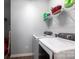 Convenient laundry room with modern white appliances and shelving for storage at 177 Willow Valley Dr, Mooresville, NC 28115