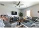 Cozy living room with a large sectional sofa, ceiling fan, and an entertainment center for relaxed Gathering time at 177 Willow Valley Dr, Mooresville, NC 28115