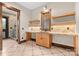 A charming wet bar with a natural wood finish features stone countertops and floating shelves with a view to the shower room at 1822 Irby Rd, Monroe, NC 28112
