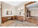 An expansive bathroom features custom vanities with lighted mirrors and views into the living room and shower at 1822 Irby Rd, Monroe, NC 28112