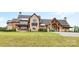 Stunning stone and wood exterior home with a porte-cochère and meticulously manicured lawn at 1822 Irby Rd, Monroe, NC 28112