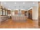 Spacious kitchen features wooden cabinets, stainless appliances, and a large central island with pendant lighting at 1822 Irby Rd, Monroe, NC 28112