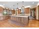 Kitchen with wood cabinets, stone backsplash, stainless appliances and large island at 1822 Irby Rd, Monroe, NC 28112