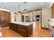 Open concept kitchen with large island and view of a great room with stone fireplace at 1822 Irby Rd, Monroe, NC 28112