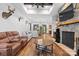 Spacious living room with a stone fireplace, beamed ceilings, and hardwood floors at 1822 Irby Rd, Monroe, NC 28112
