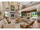 Bright living room with stone fireplace, high ceilings, and large windows overlooking the lush backyard at 1822 Irby Rd, Monroe, NC 28112