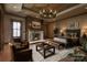 This elegant main bedroom is enhanced by a stone fireplace, decorative lighting, and an upholstered bed at 1822 Irby Rd, Monroe, NC 28112