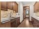 Spacious pantry features custom wood cabinetry, marble countertop, and stone backsplash at 1822 Irby Rd, Monroe, NC 28112