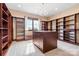 A large walk-in closet features custom shelving, a center island with drawers, and a window for natural light at 1822 Irby Rd, Monroe, NC 28112