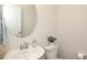 Elegant bathroom featuring a white sink with a round mirror and neutral wall color at 1914 Loggerhead Dr, Lancaster, SC 29720