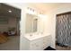 Well-lit bathroom with double vanity, modern fixtures, and an adjacent playroom entrance at 1914 Loggerhead Dr, Lancaster, SC 29720