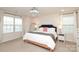 Bright bedroom featuring a large bed with a navy headboard, chandelier, and natural light at 1914 Loggerhead Dr, Lancaster, SC 29720