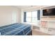 Bright bedroom with built in shelves and window seat features a flatscreen and natural lighting at 1914 Loggerhead Dr, Lancaster, SC 29720
