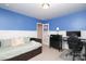 A cozy bedroom features a daybed, desk, chair, blue accent wall, and crisp white trim at 1914 Loggerhead Dr, Lancaster, SC 29720