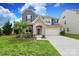 Two-story home with stone archway, two-car garage, and manicured front lawn at 1914 Loggerhead Dr, Lancaster, SC 29720
