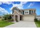Two-story home with stone archway, two-car garage, and driveway at 1914 Loggerhead Dr, Lancaster, SC 29720