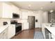 Bright kitchen featuring white cabinets, stainless steel appliances, and ample counter space at 1914 Loggerhead Dr, Lancaster, SC 29720