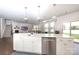 Open concept kitchen with stainless steel dishwasher and white island at 1914 Loggerhead Dr, Lancaster, SC 29720