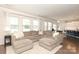 Open-concept living room boasts a large sectional sofa, bright windows, and stylish decor at 1914 Loggerhead Dr, Lancaster, SC 29720