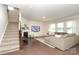 Open living room with fireplace, plush sectional sofa, and staircase at 1914 Loggerhead Dr, Lancaster, SC 29720