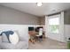 Comfortable home office with gray walls, crisp white trim, desk, computer and an armchair at 1914 Loggerhead Dr, Lancaster, SC 29720