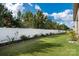 Lush green backyard featuring a well-maintained lawn and a privacy fence surrounded by trees at 2021 Pinyon Ln, Lancaster, SC 29720