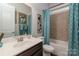 Well-lit bathroom with turquoise accents, a vanity with sink, and a shower-tub combination at 2021 Pinyon Ln, Lancaster, SC 29720