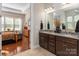 Primary bathroom featuring double sinks, granite countertops, and an entrance to the Primary bedroom at 2021 Pinyon Ln, Lancaster, SC 29720