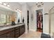 Elegant bathroom featuring double vanity, granite counters, and a well-organized walk-in closet at 2021 Pinyon Ln, Lancaster, SC 29720