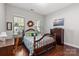 Cozy bedroom with wood floors, a decorative wreath, and natural light from the window at 2021 Pinyon Ln, Lancaster, SC 29720