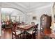 Dining area with a large wooden table and chairs open to the living and kitchen areas at 2021 Pinyon Ln, Lancaster, SC 29720