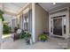 Cozy covered front porch with decorative planters and a wreath on the front door at 2021 Pinyon Ln, Lancaster, SC 29720
