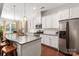 Bright kitchen features white cabinets, stainless steel appliances, granite countertops, and hardwood floors at 2021 Pinyon Ln, Lancaster, SC 29720