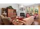 Comfortable living room with hardwood floors, fireplace, and large windows providing plenty of natural light at 2021 Pinyon Ln, Lancaster, SC 29720