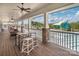 View of the pool deck area with comfortable seating, tables, and ceiling fans at 2021 Pinyon Ln, Lancaster, SC 29720