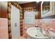 Classic bathroom showcasing pink tile, a sink, and a shower with curtain at 2025 Sagamore Rd, Charlotte, NC 28209