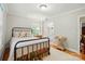 Comfortable bedroom showcases hardwood floors, a metal frame bed, and access to an en suite bathroom at 2025 Sagamore Rd, Charlotte, NC 28209
